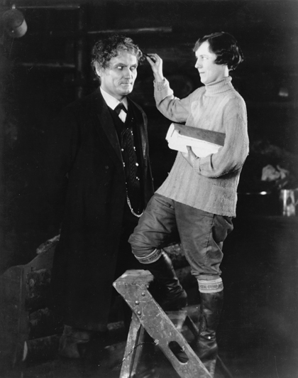 Handling continuity for The Mountain Eagle (1927), 5' 0" Alma ascends a stepladder to adjust Bernard Goetzke's hair.