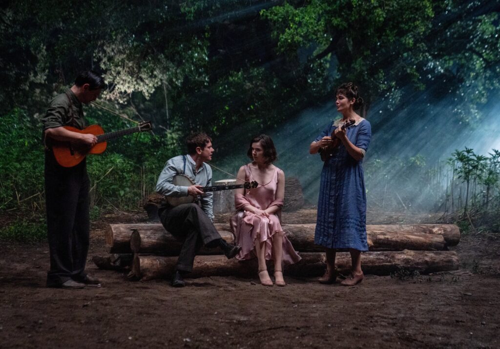 Sinners - 'Rocky Road to Dublin' performed by Remmick, played by Jack O'Connell. As featured here in a still with Hailee Steinfeld as Mary, Stack's ex-girlfriend, Peter Dreimanis as Bert, a local KKK member and Joan's husband, Lola Kirke as Joan, a KKK member and Bert's wife on Sinners questions christianity