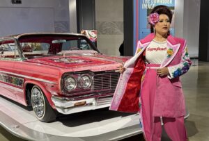 Vanessa Estrella of El Pachuco Zoot Suits Wearing a Custom designed suit to match the infamous Gypsy Rose Lowrider at the Petersen Automotive Museum photo (c) Regina Luz Jordan Hollywoodland News