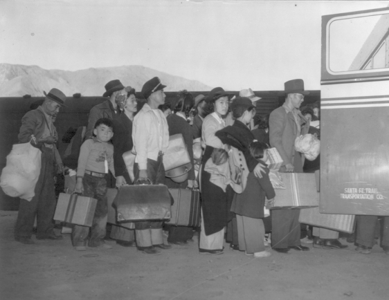 Japanese Americans waiting to board a bus that would take them to Internment Camps photo from the Library of Congress